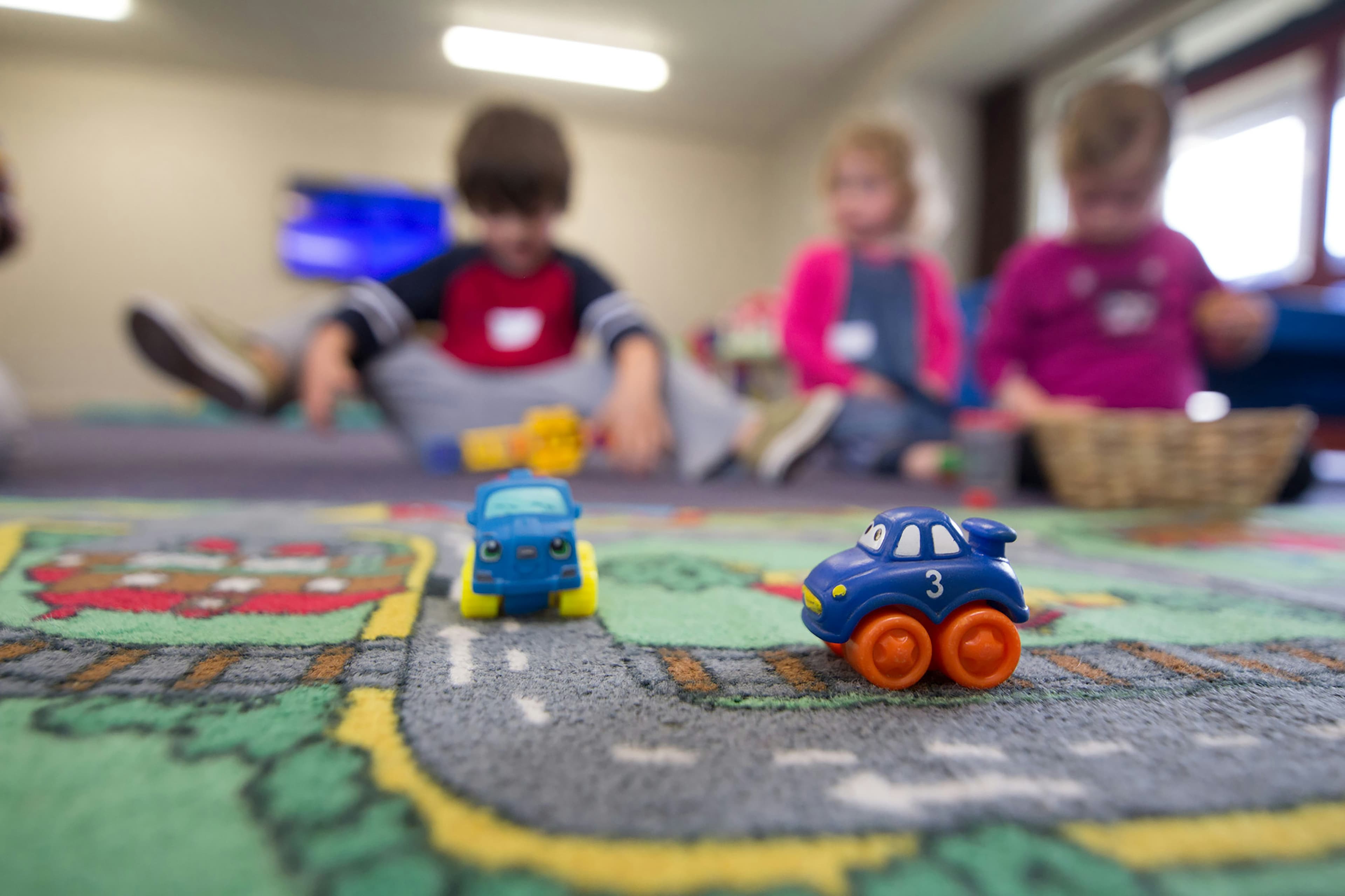 Toy truck in a daycare with children in the backround